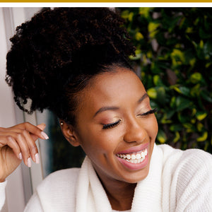 Woman laughing with beautiful natural curly hair styled in an updo