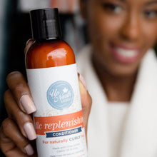 Load image into Gallery viewer, Woman smiling and holding tlc replenishing conditioner for naturally curly hair