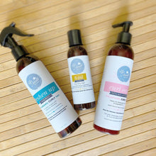 Load image into Gallery viewer, Image of all LOC Trio products including 8-oil hair blend, curl ease styling lotion, freshen up hair mist on a wooden background