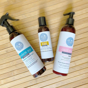 Image of all LOC Trio products including 8-oil hair blend, curl ease styling lotion, freshen up hair mist on a wooden background
